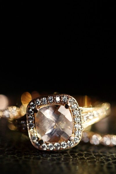 Jewels sparkle in the golden wedding rings lying on the leather