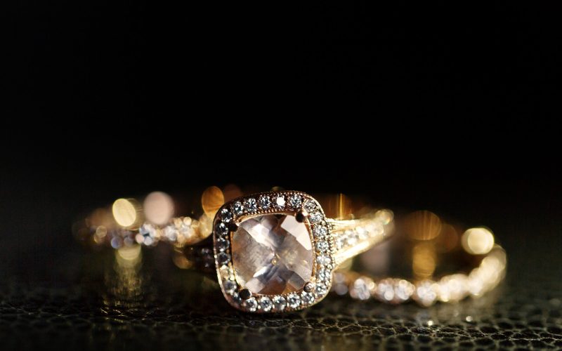 Jewels sparkle in the golden wedding rings lying on the leather Jewels sparkle in the golden wedding rings lying on the leather